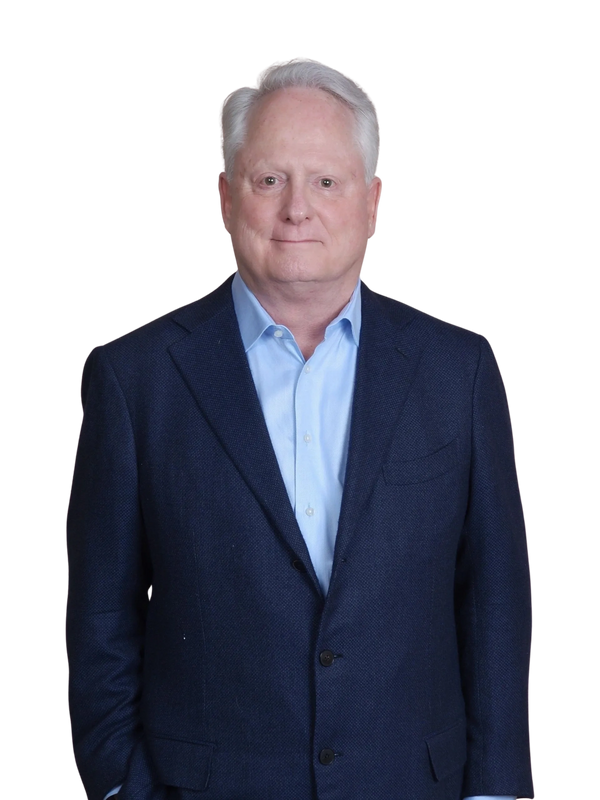 Brooks Holstein in a blue shirt and navy sport jacket.