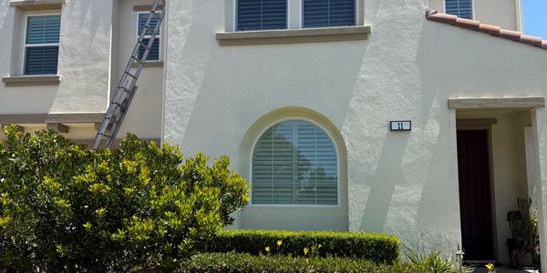 House exterior with a ladder leaning against it.