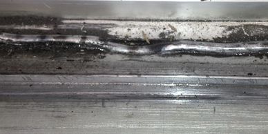 damaged sliding door track bead - repaired with a stainless steel bead replacement