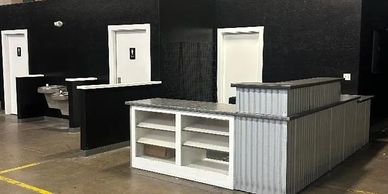 Industrial-style restroom and reception area inside a warehouse.