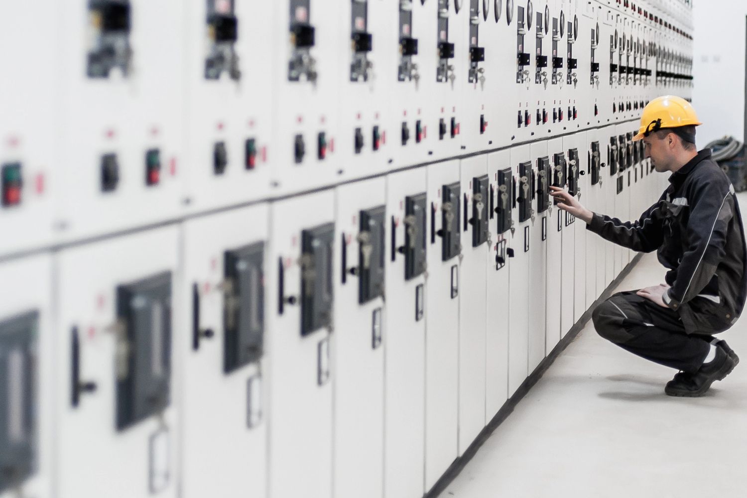 Stack of books next to pencils in a holder and a camera.
