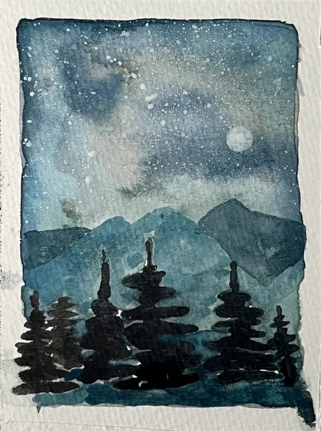 Watercolor painting of a starry night with mountains and pine trees.