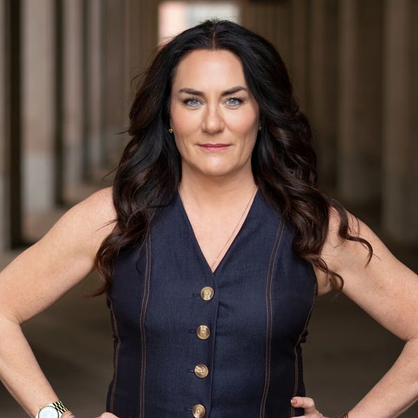 Professional portrait of keynote speaker and leadership expert Christa Haberstock standing confident