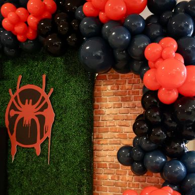 Spider-Man themed birthday backdrop with balloon decor