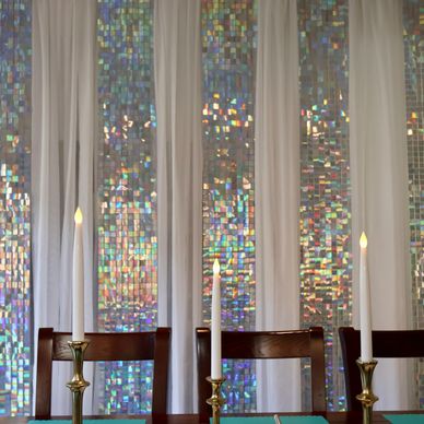 Shimmering holiday backdrop with taper candles and table decor for children to color wood ornaments