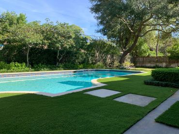 Artificial Turf around a pool with pavers
