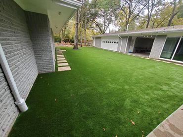 Green beautiful backyard with artificial turf