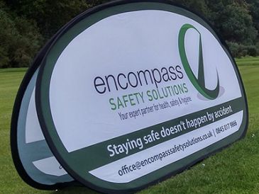 Pop-up banner for Encompass Safety Solutions on grass field.