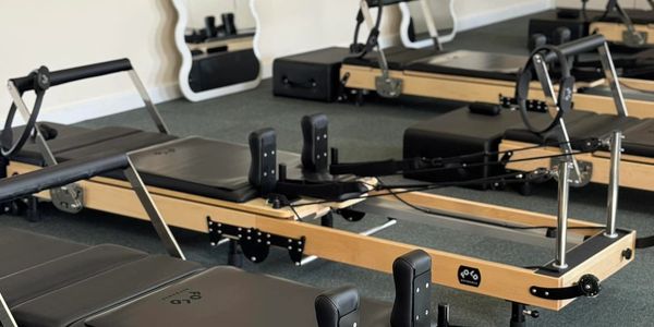 Reformer Pilates machines in a studio.