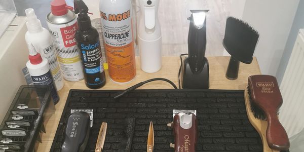 scissors and clippers arranged on a table mat