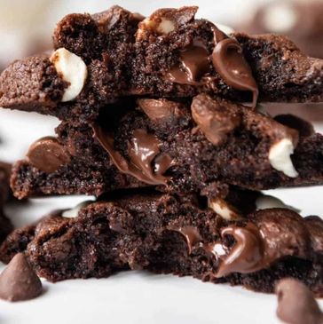 Stack of chocolate cookies with melted chocolate chips.