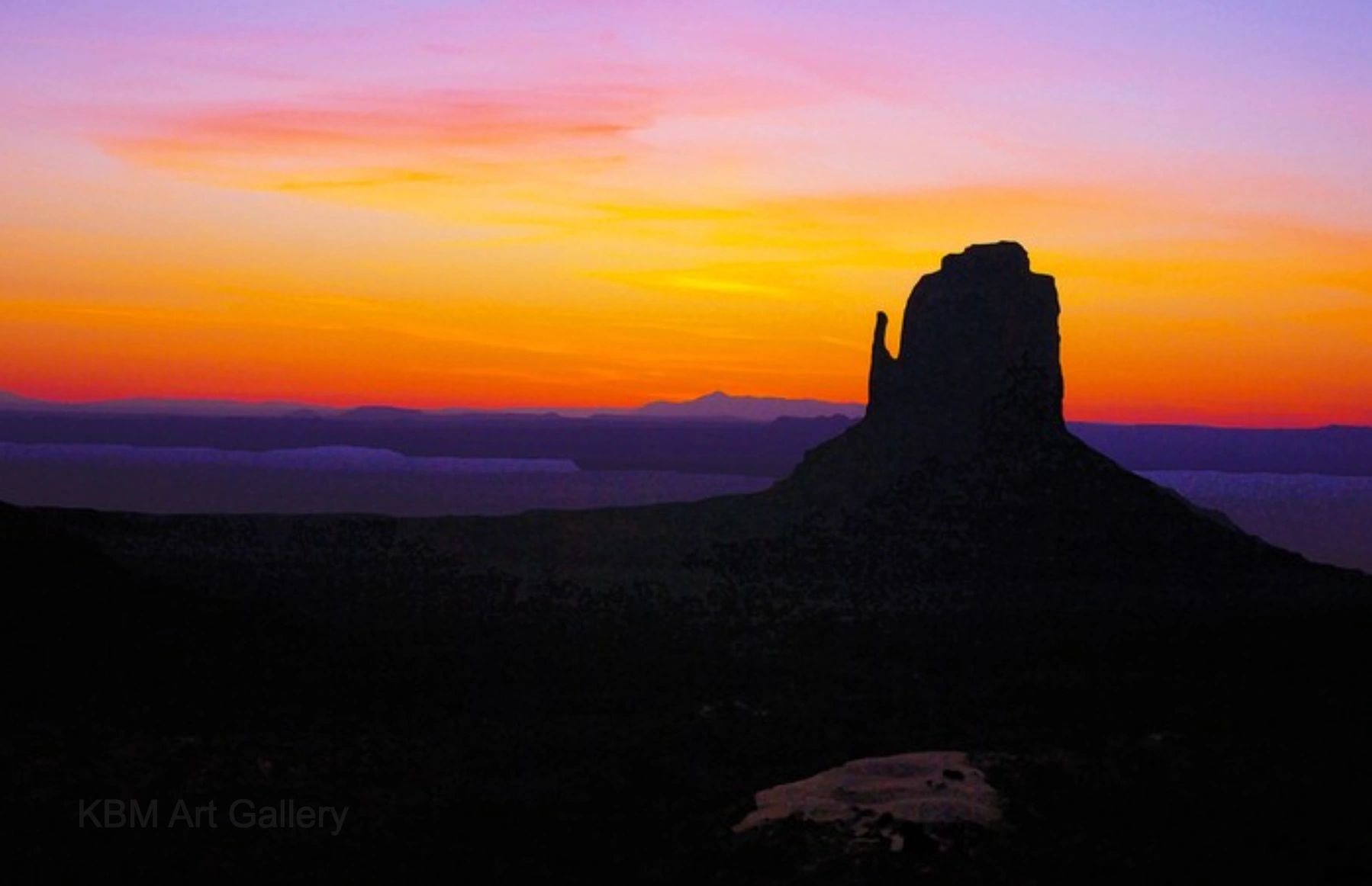 Photo of a purple/orange sunrise over a mountain.