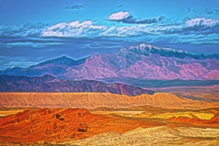 Colorful painted desert landscape with vibrant mountains under a blue sky.