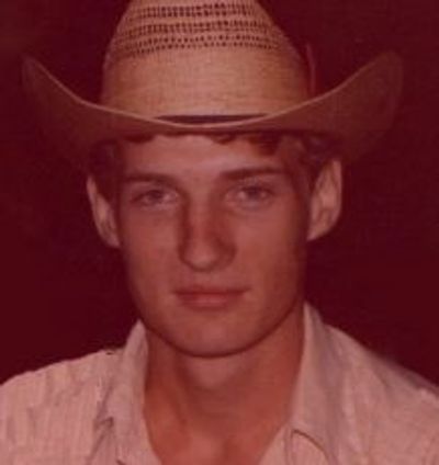 Young man wearing a cowboy hat and a light shirt.