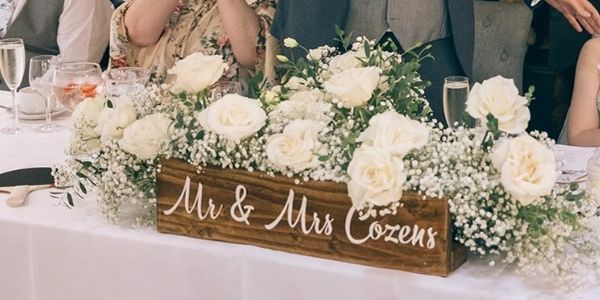 personalised top table wooden sign with wedding flowers