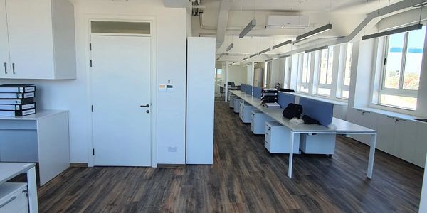 Modern efficiency, structural alterations to convert 5 offices into one big working space. 