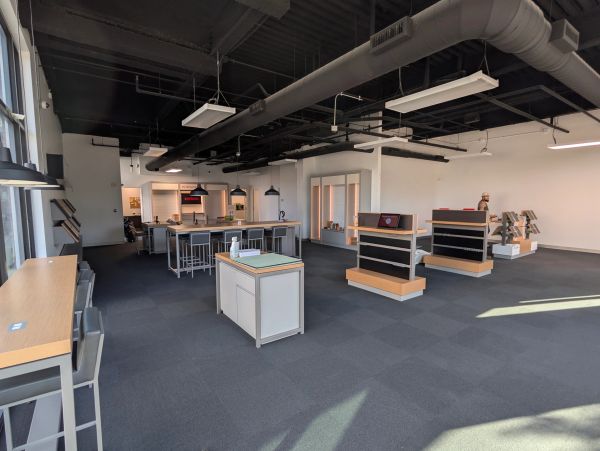 Modern, spacious office or showroom interior with display shelves and seating.