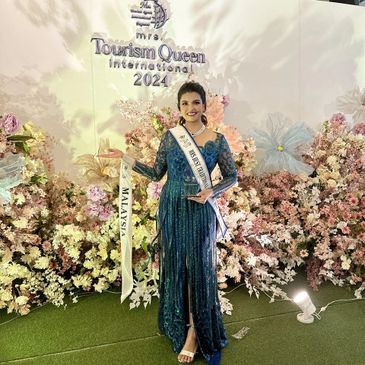 Winner of Mrs. Tourism Queen International 2024 from Malaysia posing with sash.