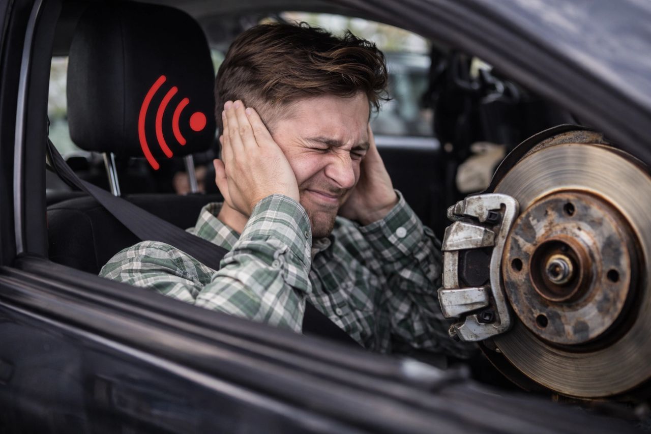image of driver hearing his brakes and covering ears because sound is loud