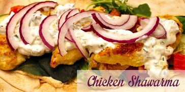 Chicken shawarma with red onions and white sauce on pita bread.
