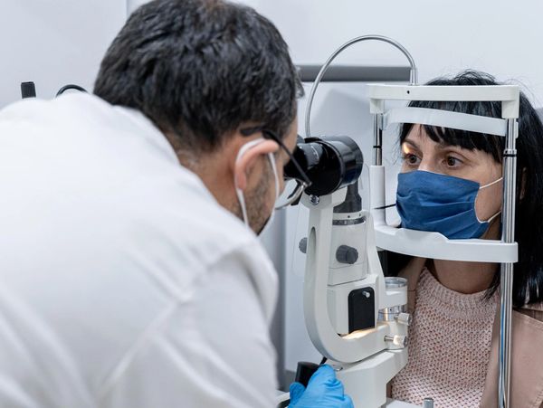 Optician measuring a woman's eyesight
