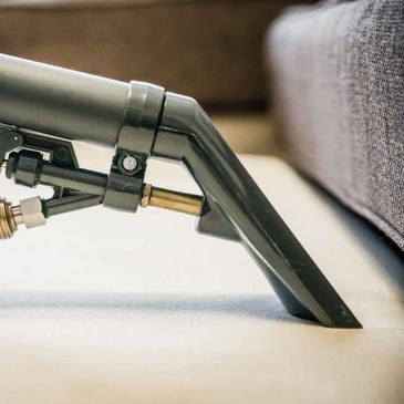 Close-up of a hand holding a fabric cleaning tool.