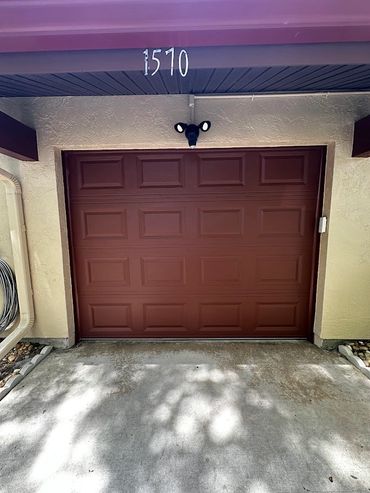 Closed brown garage door with house number 1570 above it.