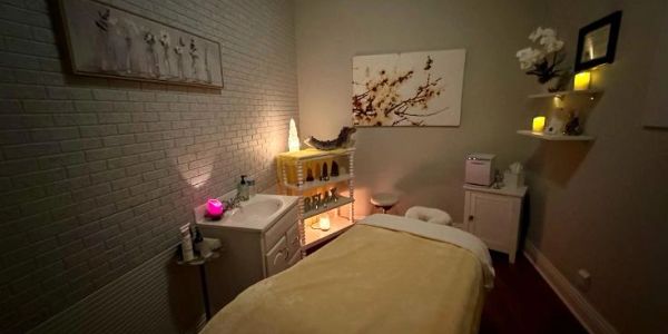 Cozy massage room with soft lighting and clean decor.