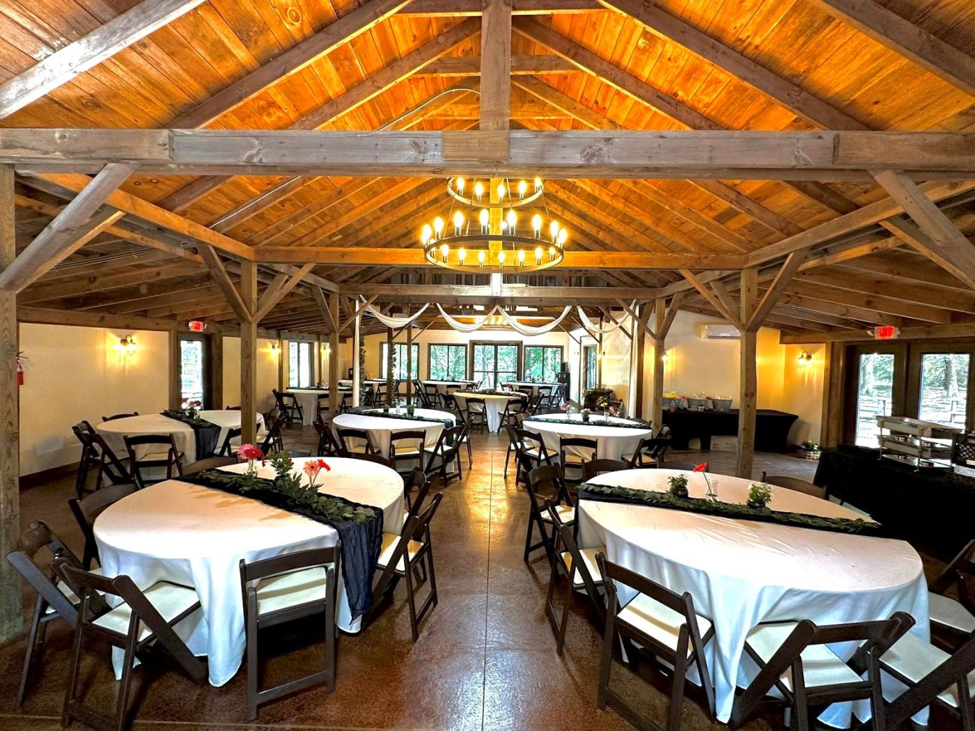 Reception hall inside The Gables with wooden beams and decorated tables