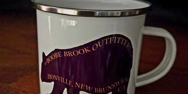 White enamel mug with a black buffalo design and text.