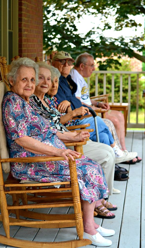 elderly residents enjoying an afternoon on the front porch