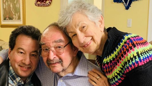 A resident with his wife and son posing for a photo.