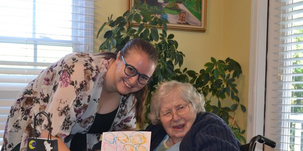 Art therapist and resident proudly display current artwork