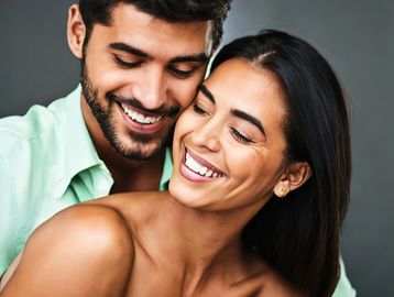 Image of man and woman smiling embracing each other arm