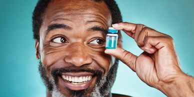 Middle aged male holding and staring at civil of botox