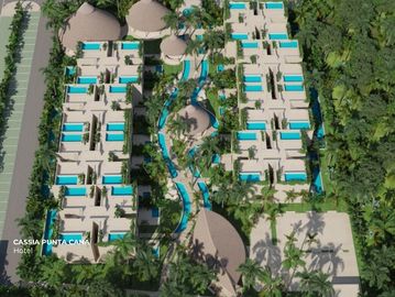 Aerial view of a tropical hotel resort with multiple pools and lush greenery.
