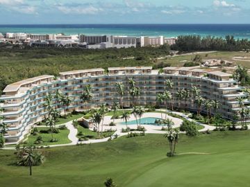 Curved beachfront resort with a pool and palm trees overlooking a golf course.