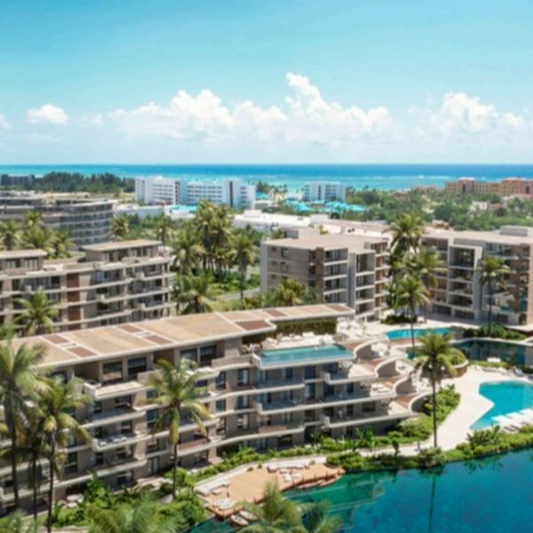 Modern beachfront apartments with pools and lush greenery.