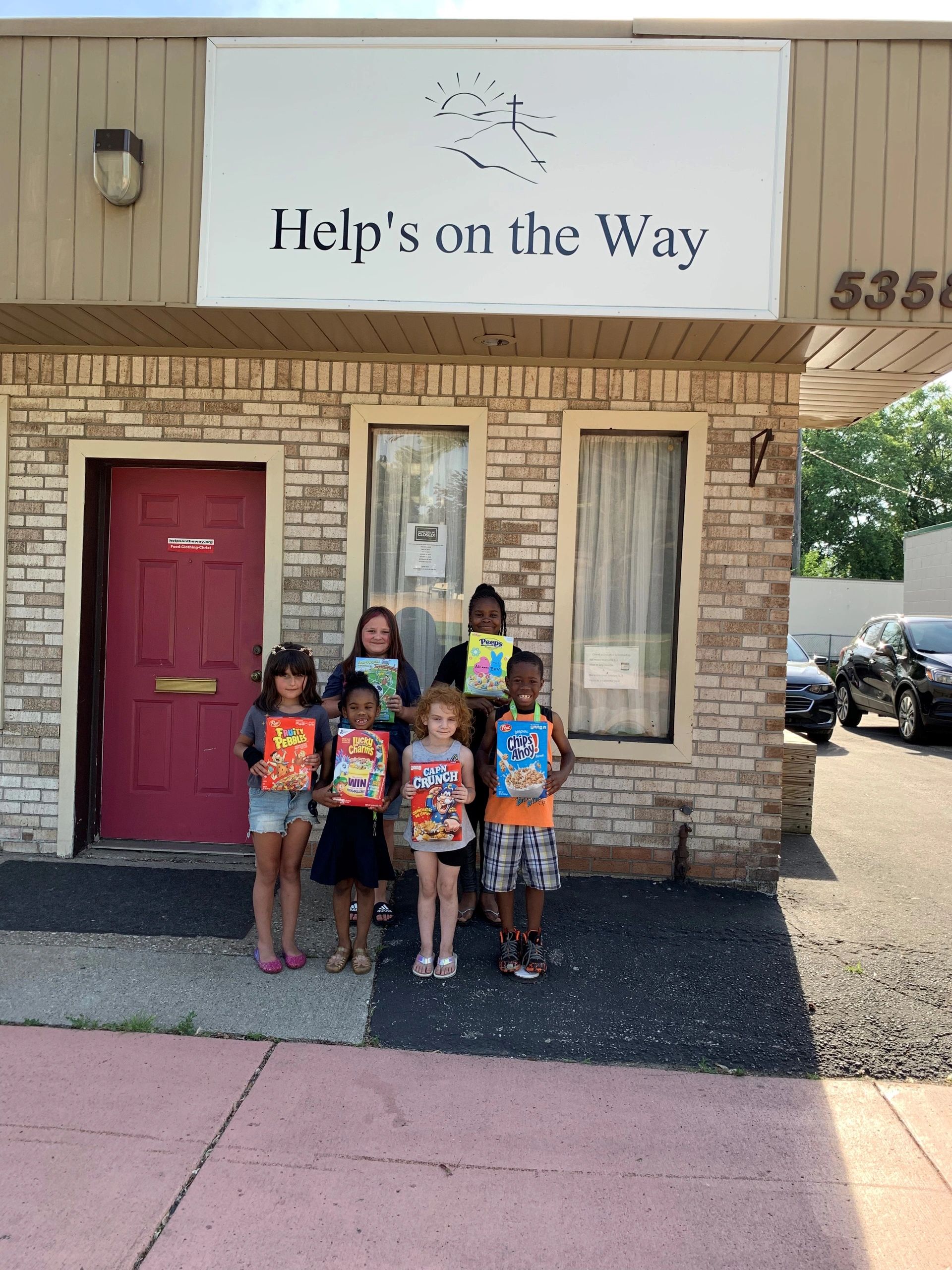 Children receiving cereal from cereal drive