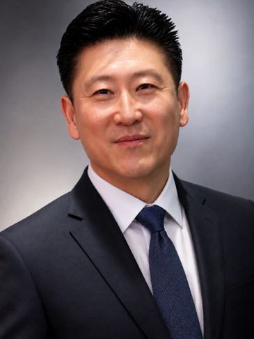 Professional man in suit and tie smiling.