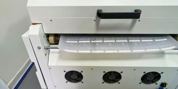 A machine printing multiple labels continuously.