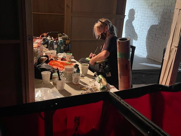 woman on film set painting, scenic