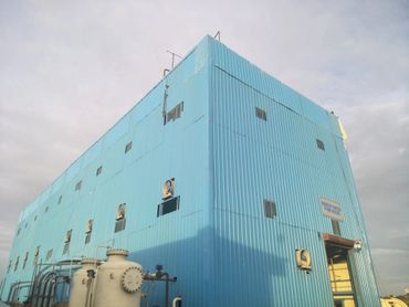 Large blue industrial building labeled 'Makeup Water Pump House' with attached machinery.