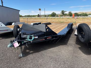 Flatbed trailer parked outdoors on asphalt.