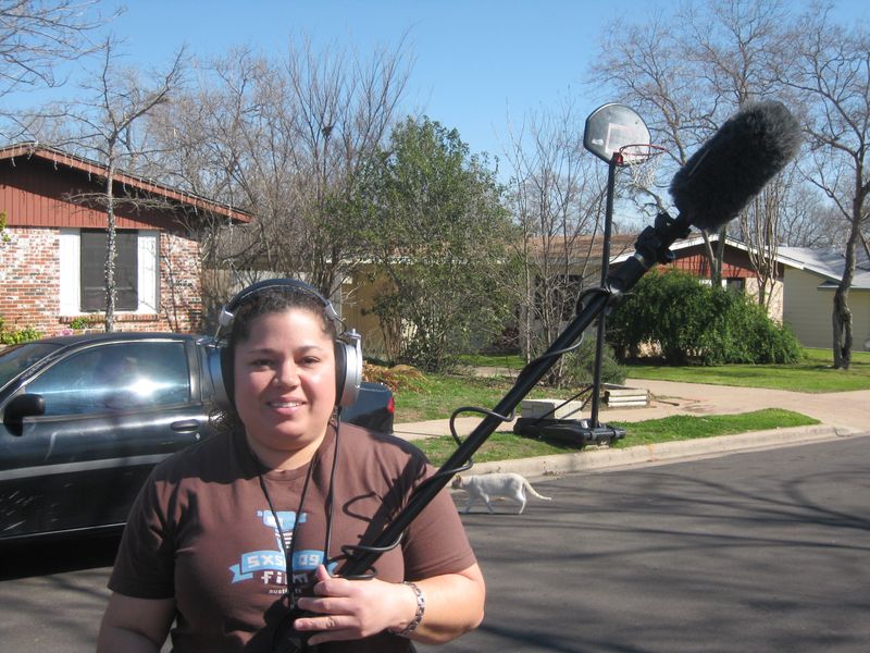 Female Filmmaker holding boom mic