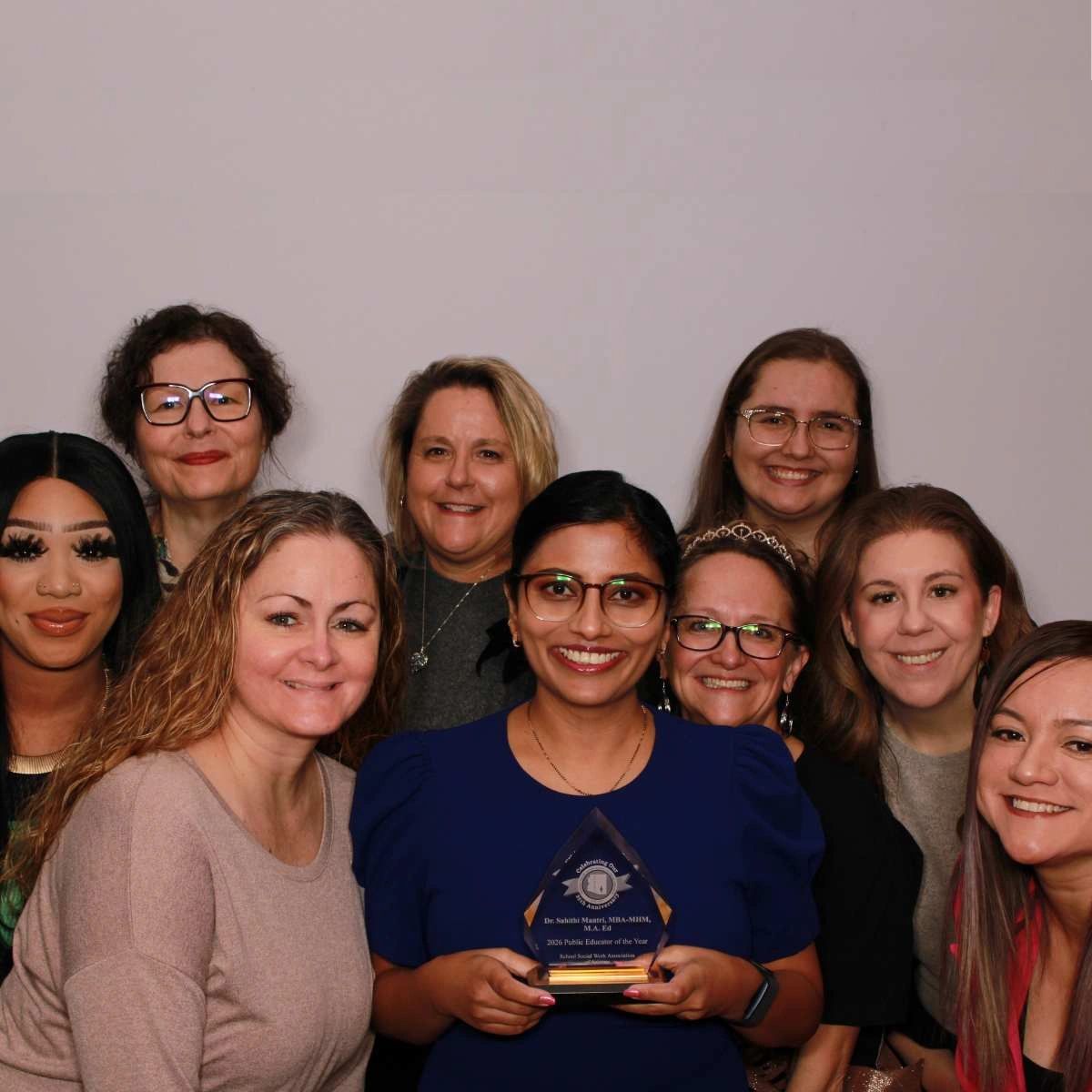 A team member poses with her award received at an annual education conference in Scottsdale