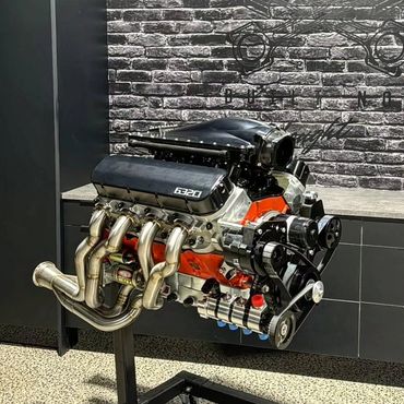 High-performance 6320 engine displayed against a brick wall.