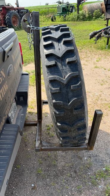 Heavy-duty tire mounted on a truck rack.