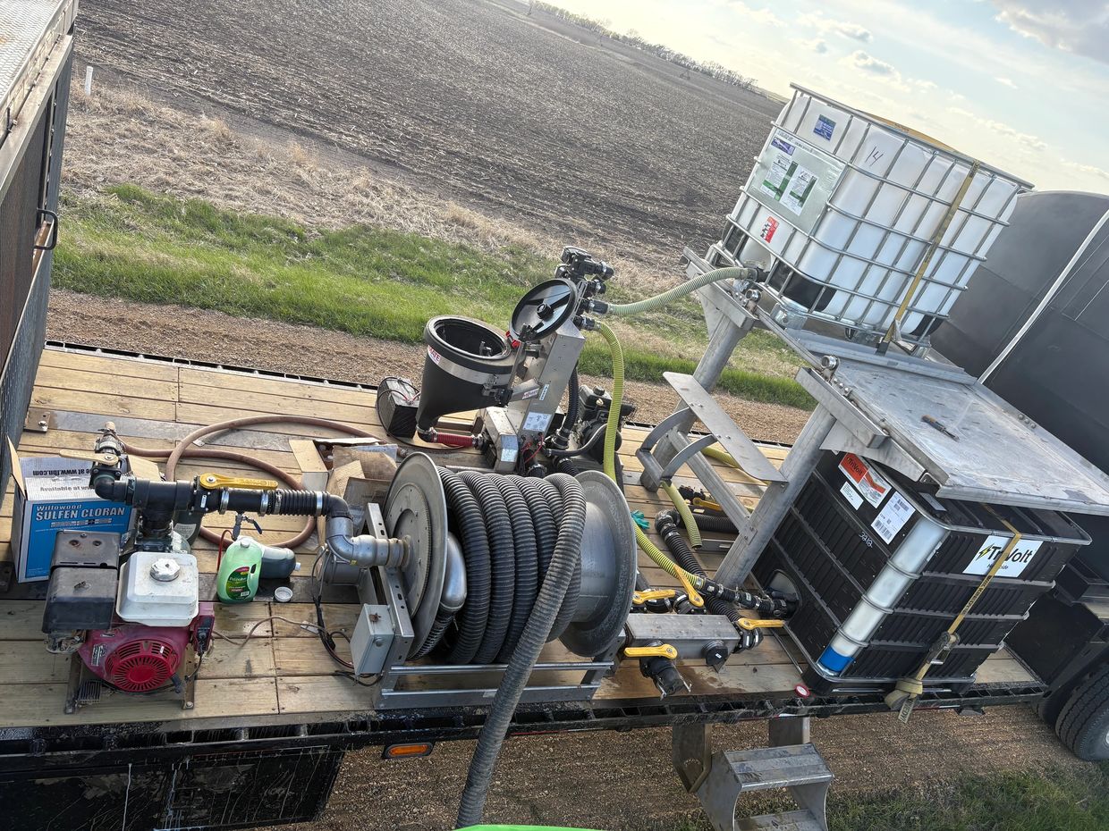 Industrial equipment setup on a trailer in a field.
