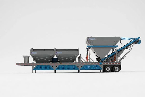 Side view of a mobile concrete batching plant on a trailer.